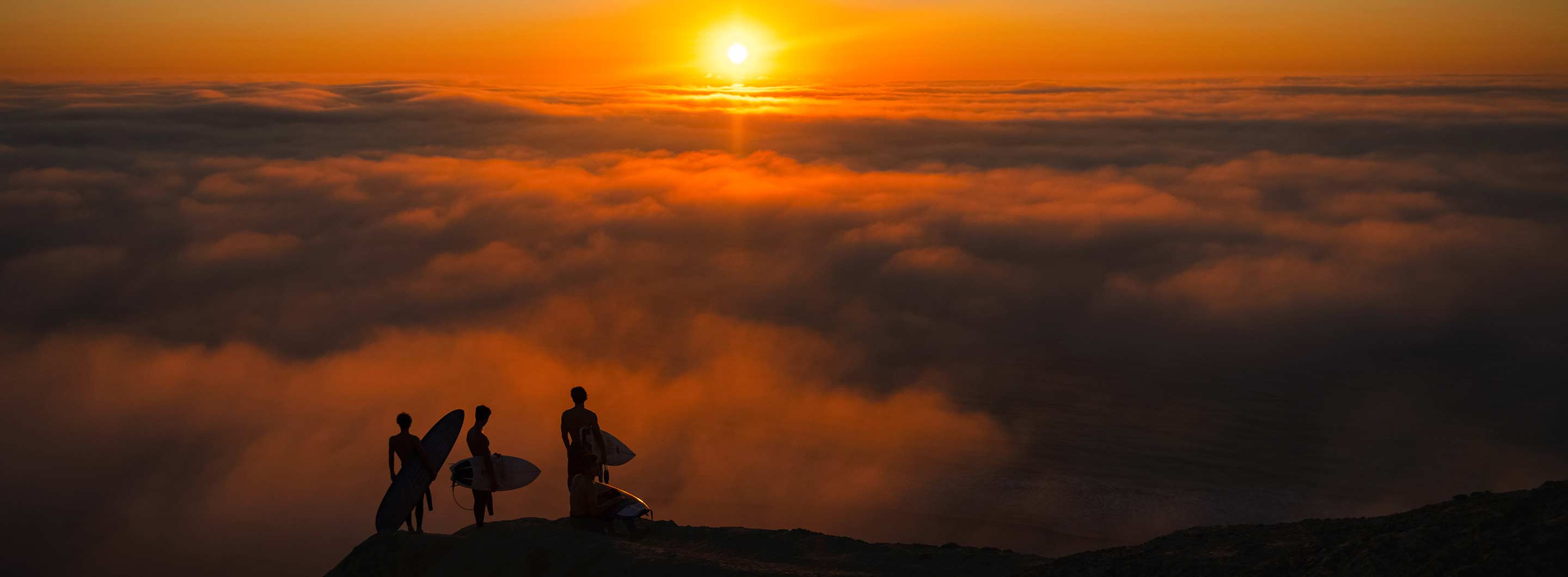 surfers at sunset